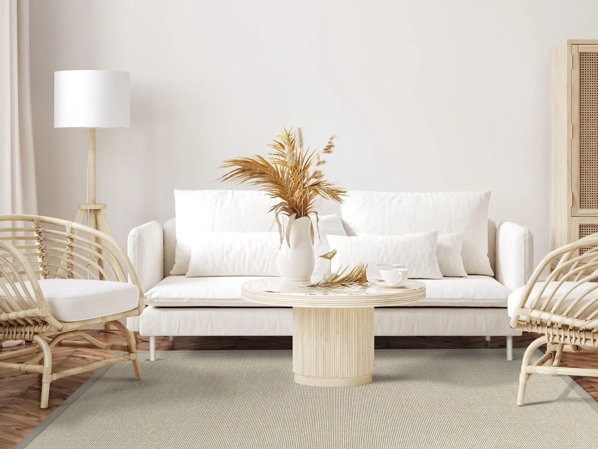 Photo of a living room with a white couch and rattan chairs and a Mara S2 Sand sisal rug.